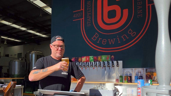 Adsy joins Carbon 6 Brewing at the bar, showcasing craft beer and a vibrant brewery atmosphere.