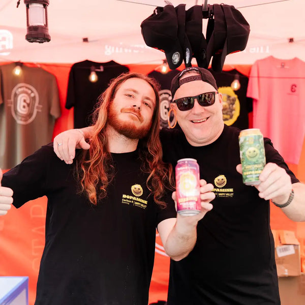 Two men at Crafted Festival Gold Coast showcasing Carbon 6 Brewing beers with smiles.