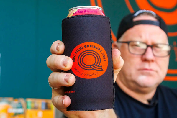 Man holding a Carbon 6 Can Cooler with a can inside, showcasing the best new brewery award logo.