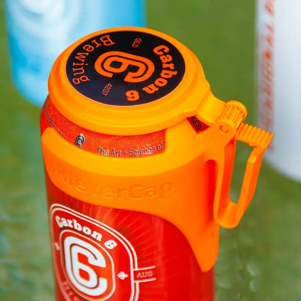 C6 Klever Cap on a beer can, featuring an orange flip lid designed to keep drinks clean and free from debris.