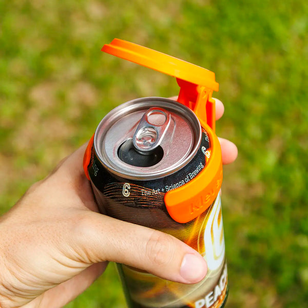 C6 Klever Cap on a beer can, showcasing the clip and flip lid design for a clean sip outdoors.