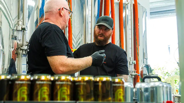 Brewery workers discussing beer canning