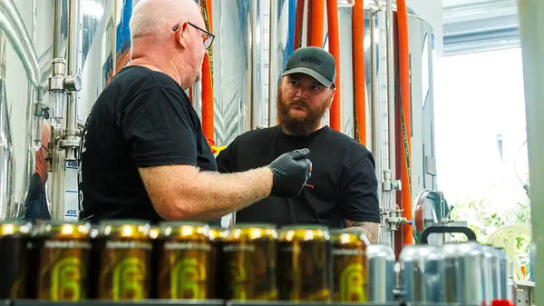 Brewery workers discussing beer canning