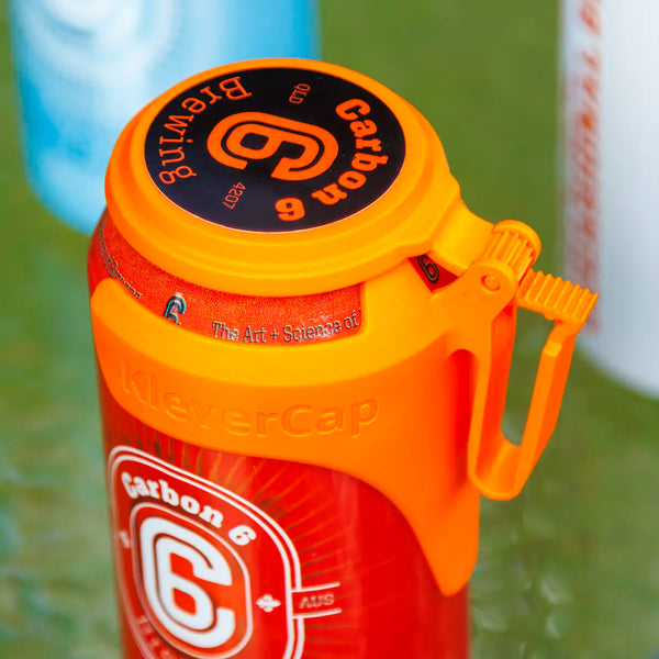 C6 Klever Cap on a beer can, featuring an orange flip lid designed to keep drinks clean and free from debris.