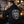 Man wearing Carbon 6 Can Head Brewer Fleece Hoodie, showcasing unique design while enjoying a beer.