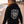 Woman wearing a Carbon 6 Can Head Brewer Fleece Hoodie with a graphic design on the back, standing on the beach.